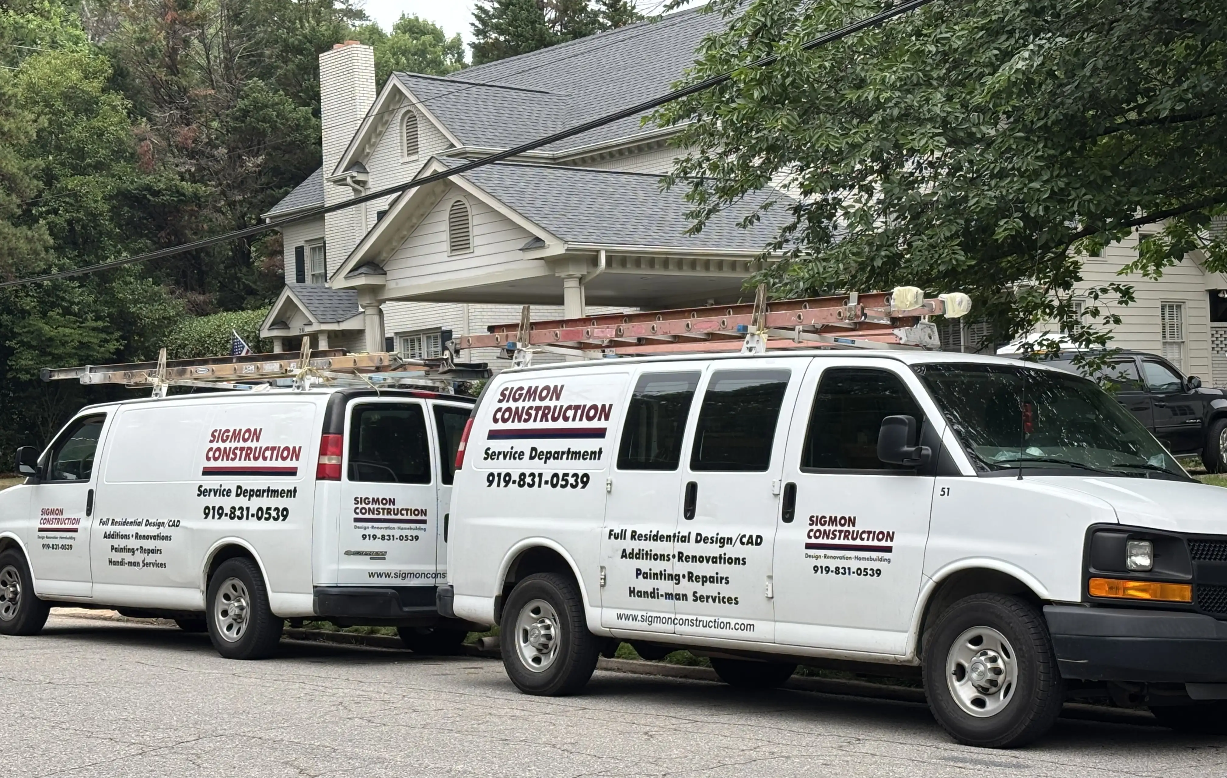 Branded service van with equipment at a residential job site
